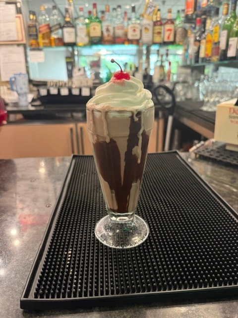 Creamy diner milkshake topped with a cherry